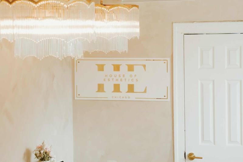 HE gold sign with chandelier